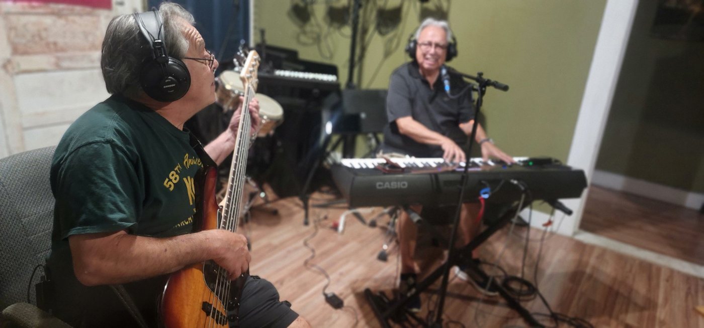 Musicians recording together in a studio