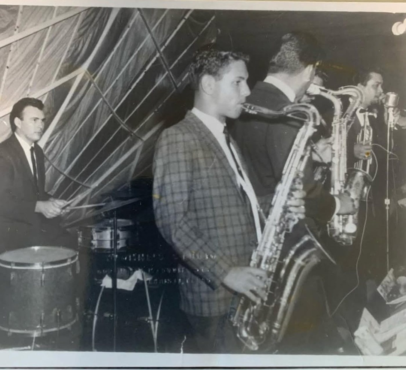 Vintage black and white performance photo of saxophone players on stage