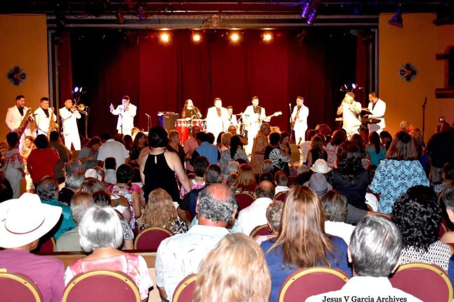 Band performing for a full theater audience